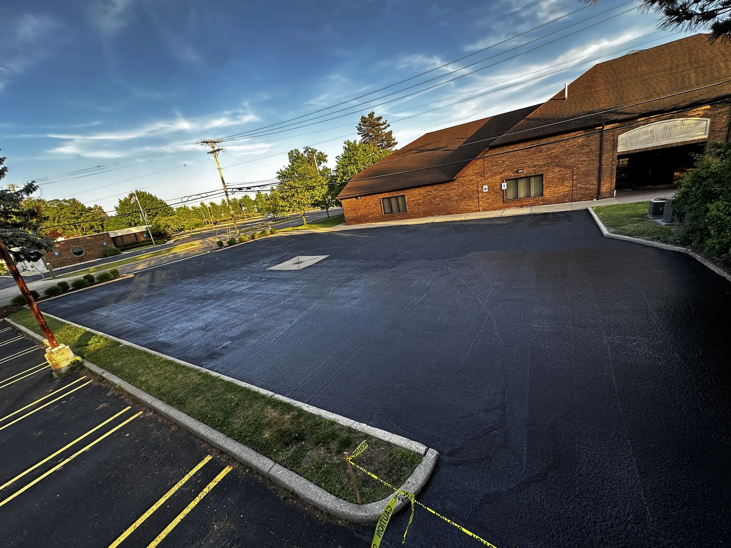 Freshly sealcoated commercial parking lot by Elite Asphalt